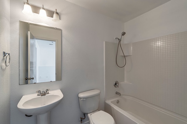 bathroom with a sink, toilet, and shower / washtub combination