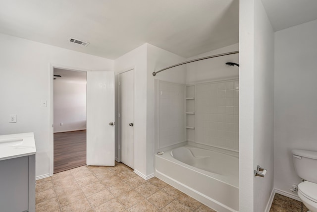 bathroom with vanity, baseboards, visible vents, shower / bath combination, and toilet