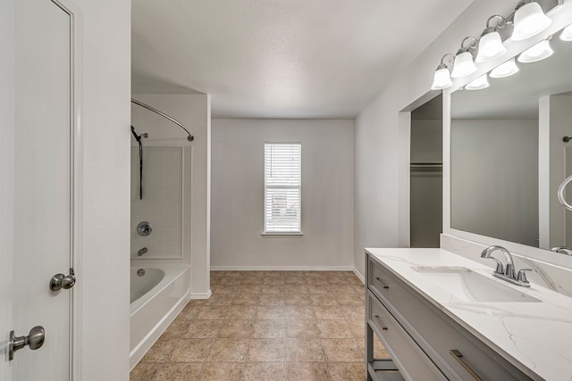 bathroom featuring shower / bath combination, baseboards, and vanity