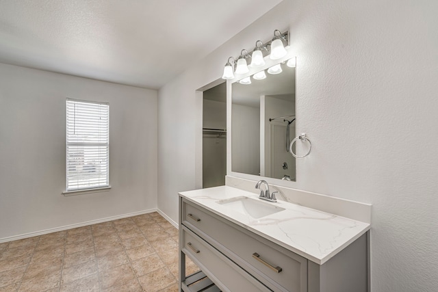 bathroom featuring baseboards and vanity