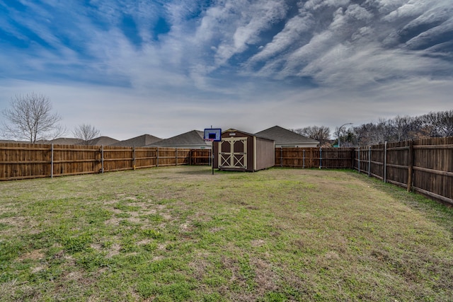 view of yard featuring an outdoor structure, a storage unit, and a fenced backyard