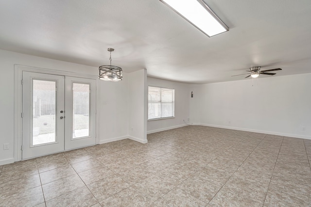 unfurnished room featuring french doors, baseboards, and ceiling fan