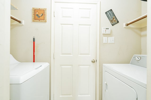 washroom featuring laundry area and washer and dryer