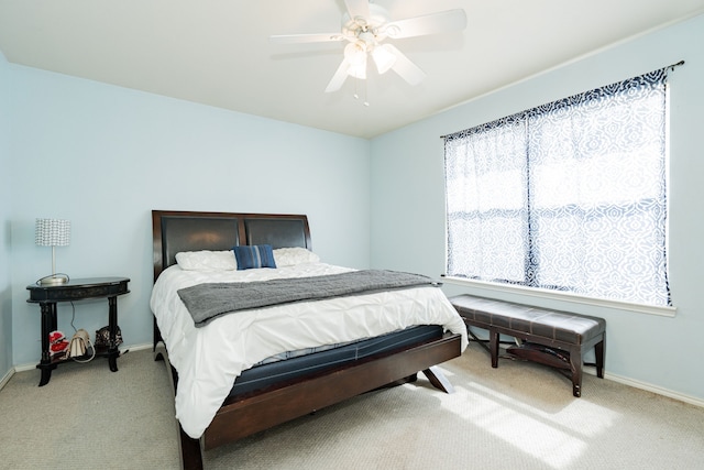 carpeted bedroom featuring a ceiling fan and baseboards