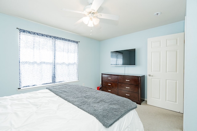 bedroom with light carpet and ceiling fan