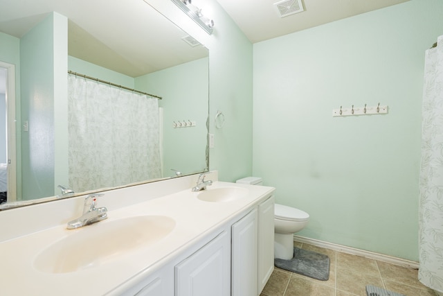 bathroom with toilet, baseboards, visible vents, and a sink