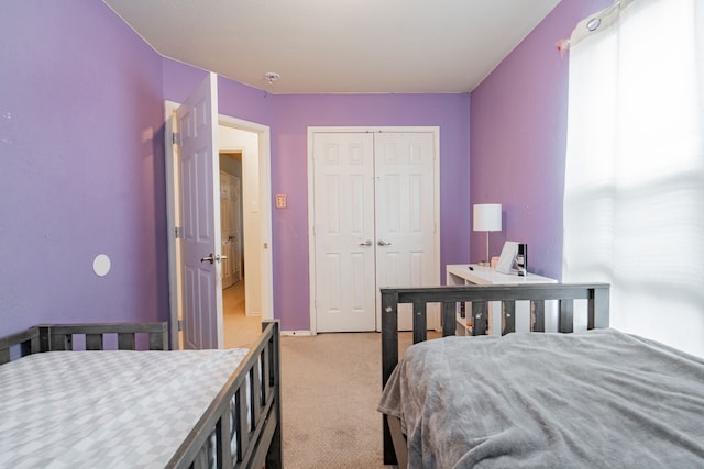 carpeted bedroom with a closet