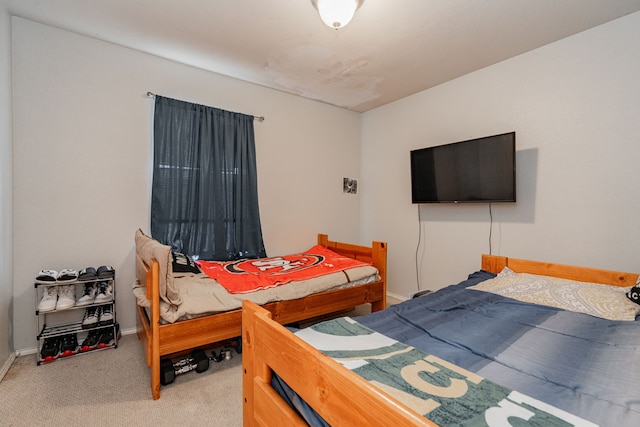 bedroom featuring carpet and baseboards