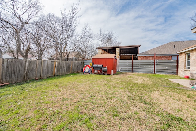 view of yard with an outbuilding and a fenced backyard