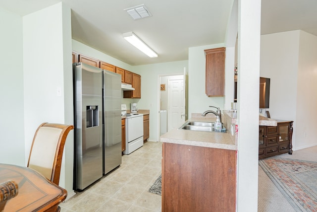 kitchen with white range with electric stovetop, light countertops, under cabinet range hood, stainless steel refrigerator with ice dispenser, and a sink