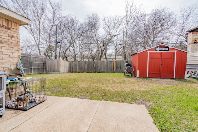 view of yard with an outbuilding, a fenced backyard, a patio, and a shed