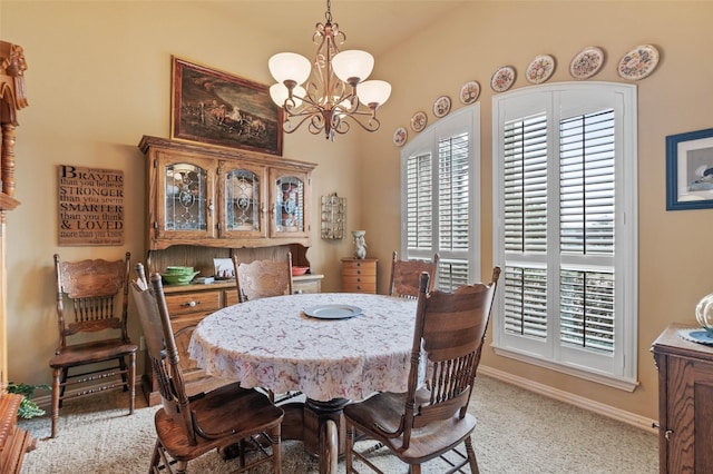 dining space featuring baseboards and an inviting chandelier