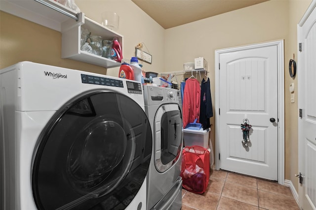 laundry room with tile patterned flooring, laundry area, and washer and clothes dryer