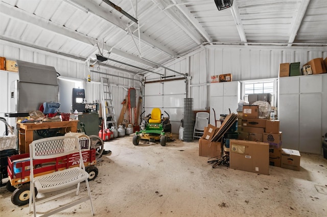 garage with a garage door opener and metal wall