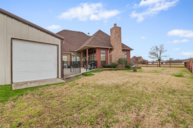 exterior space featuring fence and a garage