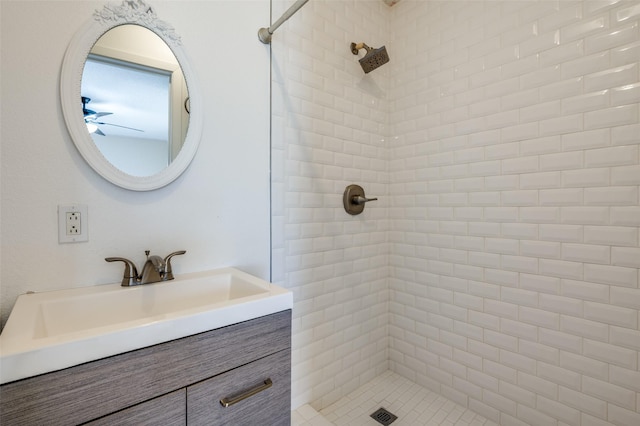 full bath featuring vanity and tiled shower