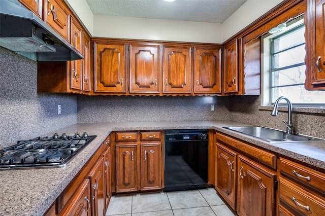 kitchen featuring under cabinet range hood, a sink, decorative backsplash, dishwasher, and stainless steel gas cooktop