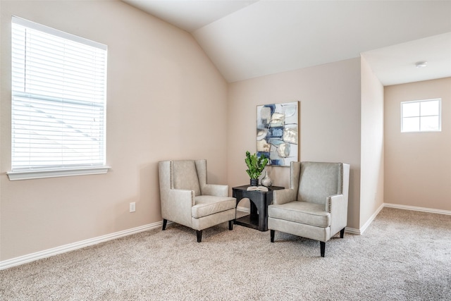 sitting room with light carpet, baseboards, and vaulted ceiling