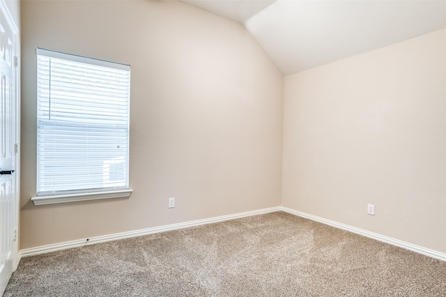 unfurnished room featuring lofted ceiling, baseboards, and carpet