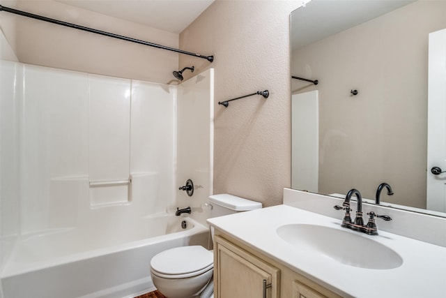 full bath with toilet, a textured wall, vanity, and shower / bathing tub combination