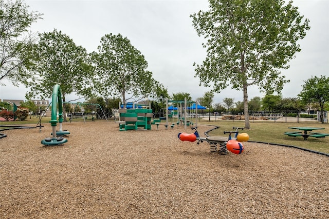 communal playground featuring a lawn