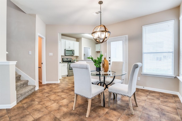 dining area featuring a chandelier, stairway, visible vents, and baseboards