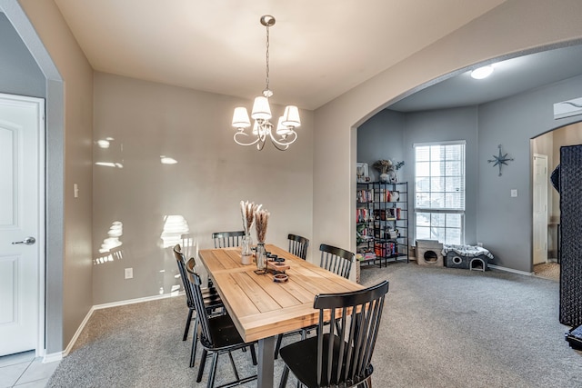 dining room with arched walkways, carpet floors, and a notable chandelier