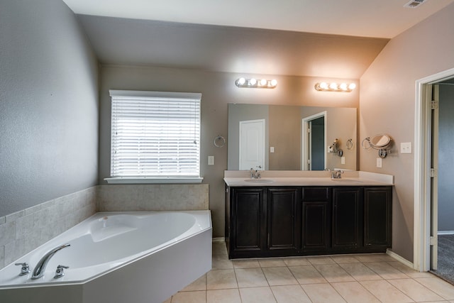 full bath with double vanity, tile patterned flooring, a sink, and a bath