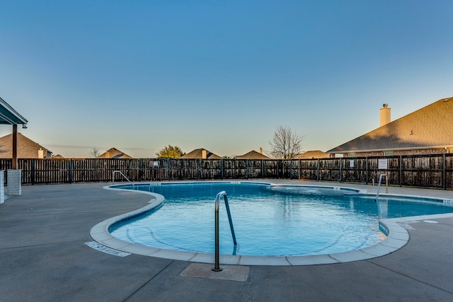 pool featuring fence and a patio