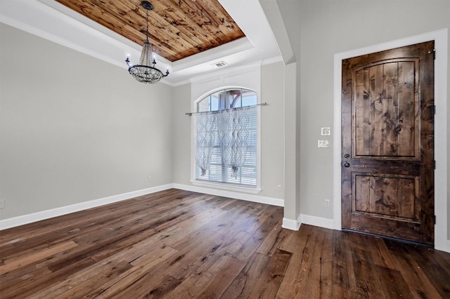 entryway featuring baseboards, visible vents, a raised ceiling, dark wood-style flooring, and a chandelier