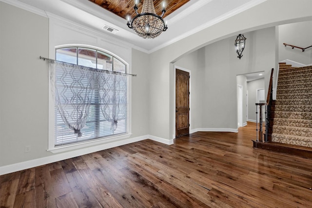 unfurnished dining area with a wealth of natural light, visible vents, a chandelier, and a tray ceiling