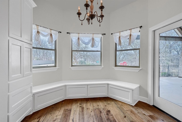 interior space featuring light wood-type flooring and an inviting chandelier