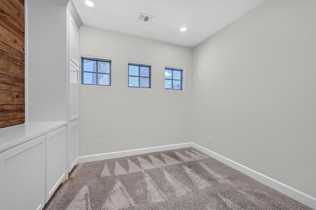 unfurnished room with recessed lighting, visible vents, light carpet, and baseboards