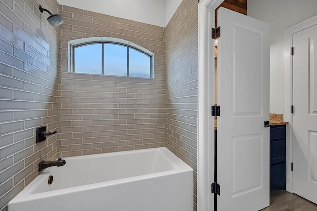 bathroom featuring a washtub and walk in shower