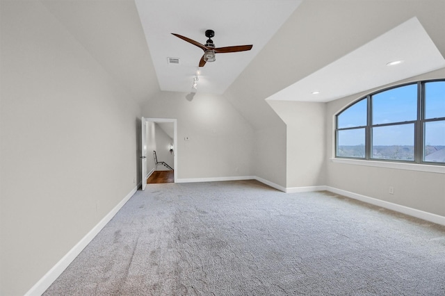 additional living space with lofted ceiling, carpet, visible vents, and baseboards