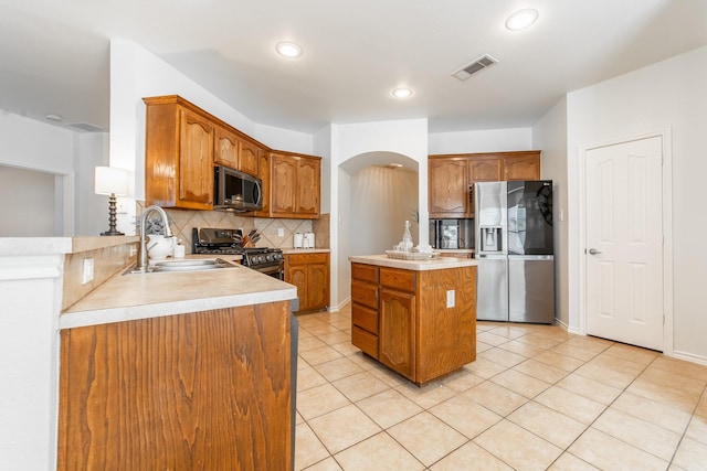 kitchen featuring light tile patterned floors, visible vents, appliances with stainless steel finishes, light countertops, and a sink