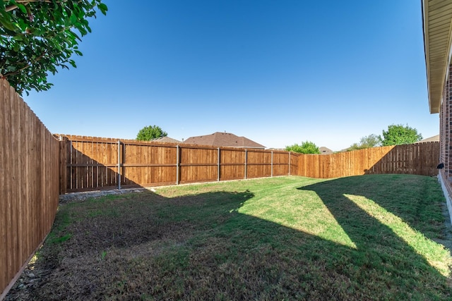 view of yard with a fenced backyard