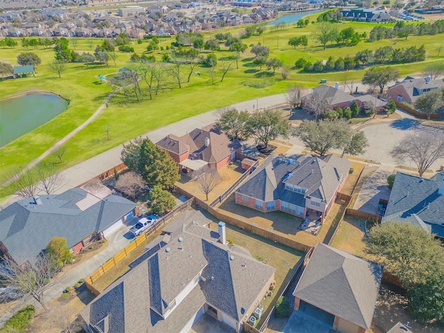 birds eye view of property with golf course view, a water view, and a residential view