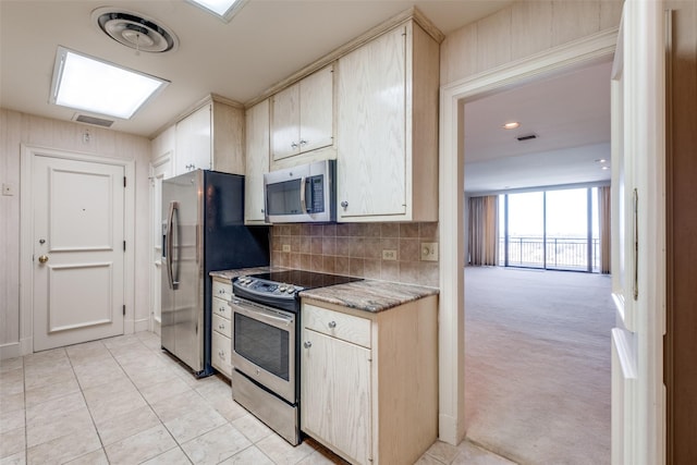 kitchen featuring tasteful backsplash, light colored carpet, light countertops, visible vents, and appliances with stainless steel finishes