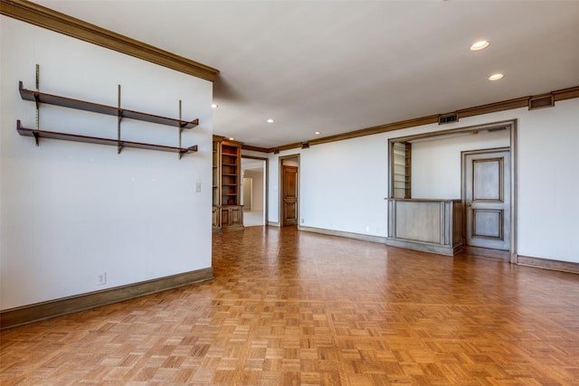 empty room featuring baseboards, visible vents, crown molding, and recessed lighting