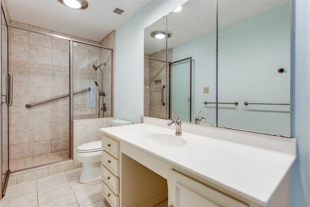 bathroom featuring vanity, tile patterned flooring, a shower stall, and toilet