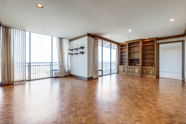 unfurnished living room with a wall of windows, recessed lighting, crown molding, and baseboards