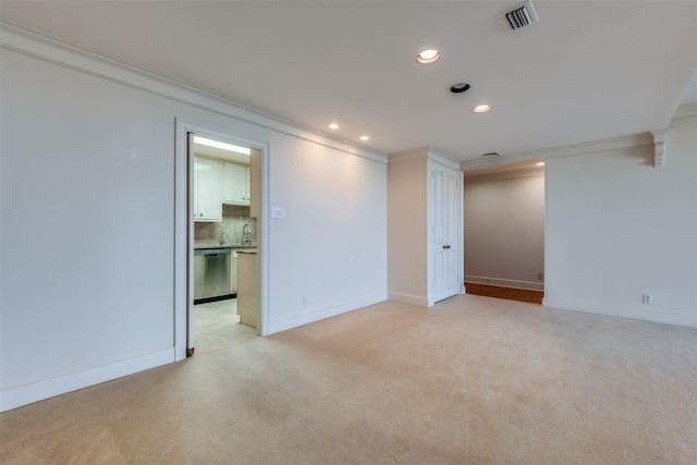 spare room with light carpet, visible vents, baseboards, ornamental molding, and recessed lighting