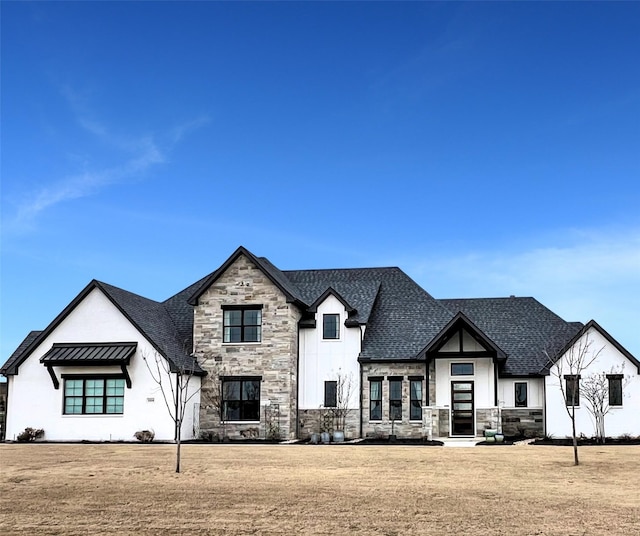 view of front of home featuring a front lawn, stone siding, and a shingled roof