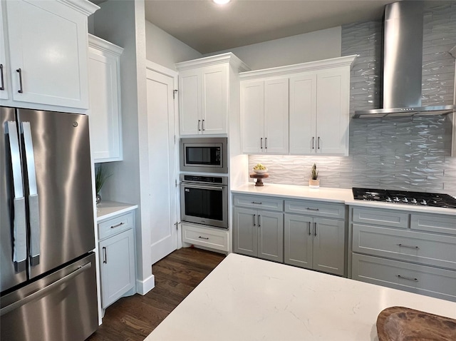 1000 Sutherland Cres, Northlake, TX 76247 - kitchen with appliances with stainless steel finishes, wall chimney range hood, dark wood finished floors, light countertops, and tasteful backsplash