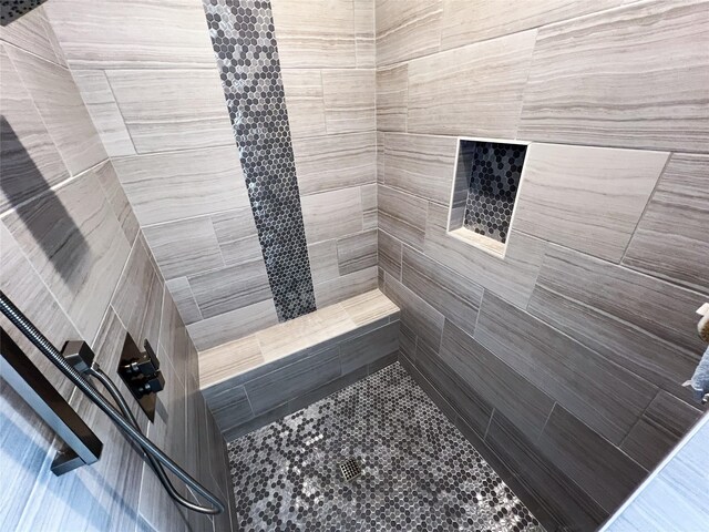 full bath featuring wood finished floors, two vanities, baseboards, and a sink