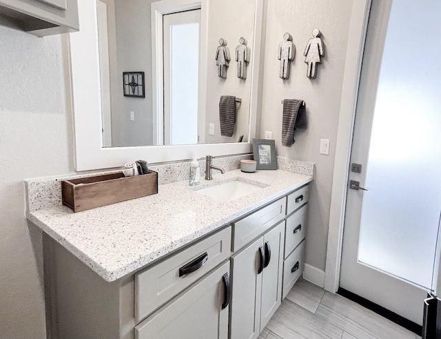 bathroom featuring vanity and baseboards