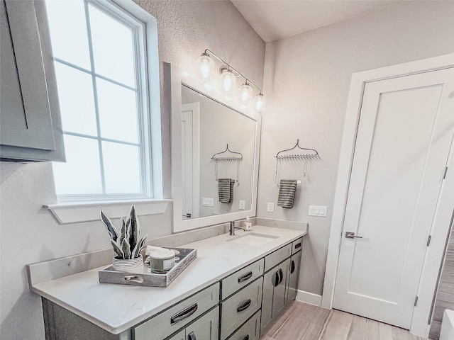 1000 Sutherland Cres, Northlake, TX 76247 - bathroom featuring vanity, wood finished floors, and baseboards