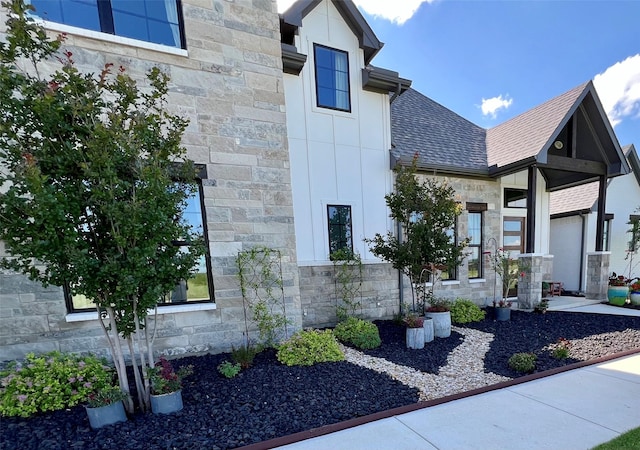 1000 Sutherland Cres, Northlake, TX 76247 - view of home's exterior featuring stone siding, roof with shingles, and board and batten siding