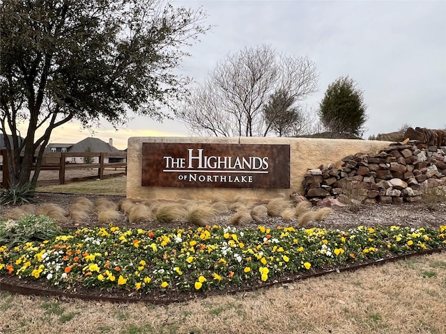 community / neighborhood sign with fence